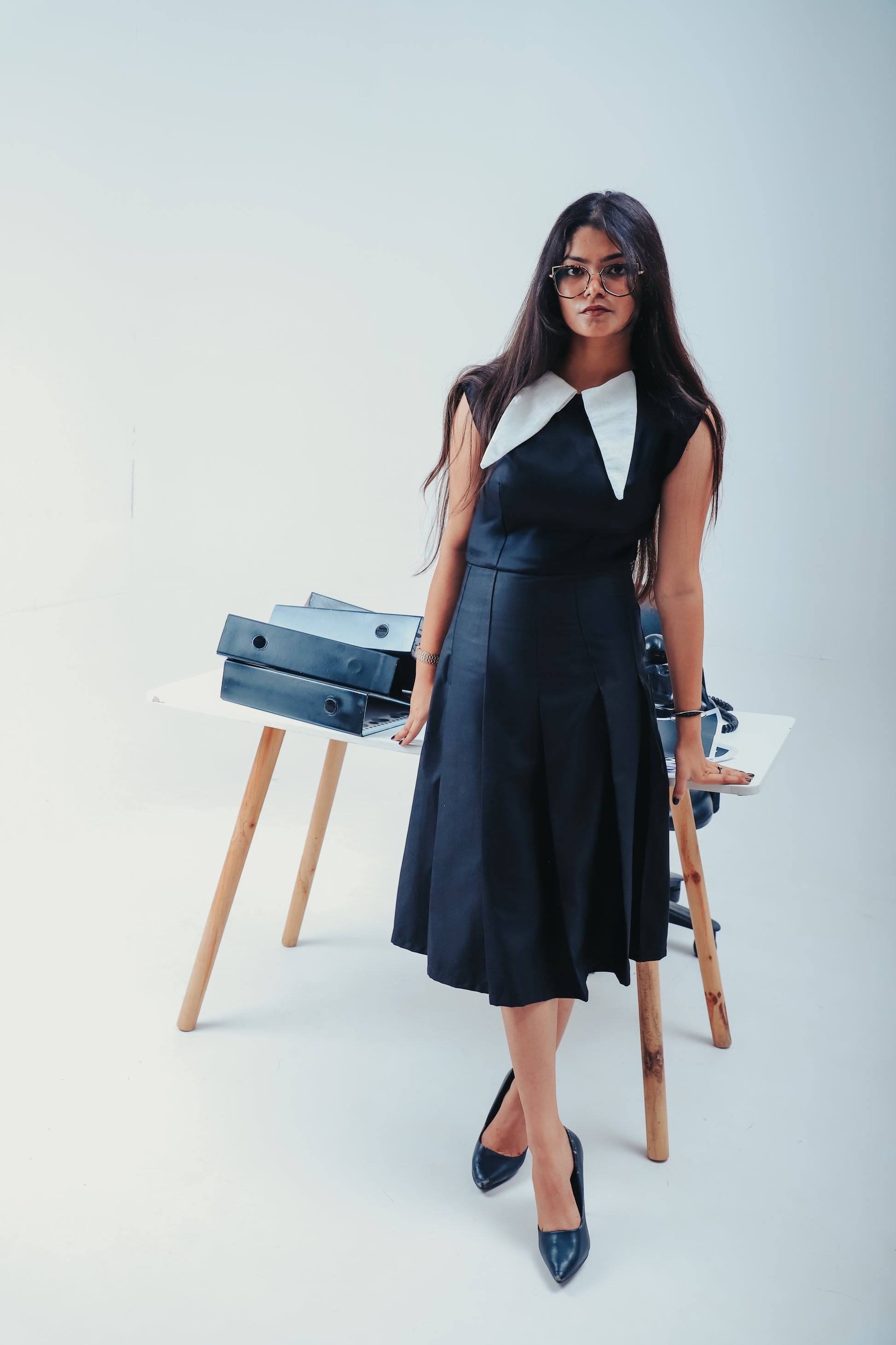black pleated dress with collar, formal black dress for work, WERQ white collar pleated outfit, tailored dress for Indian women, elegant professional dress, premium workwear India, structured black formal dress, dress with pleats and collar, bold statemen