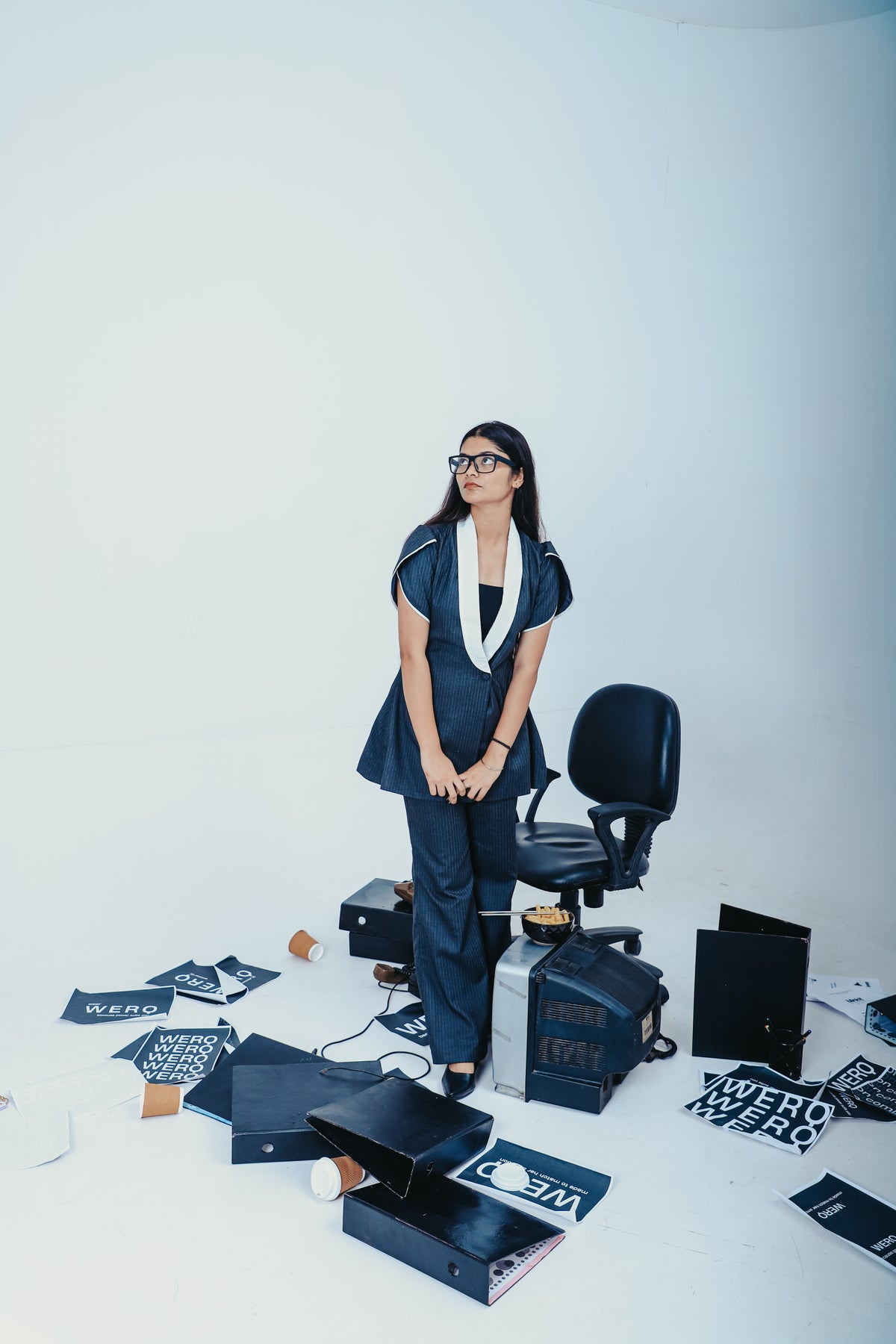 grey pinstripe pantsuit, feminine tailored suit India, WERQ formal women’s suit, soft structured grey blazer, professional grey co-ord for women, boot-cut trousers formalwear, fit and flare blazer suit with tulip sleeves, fitted blazer set India, sustaina