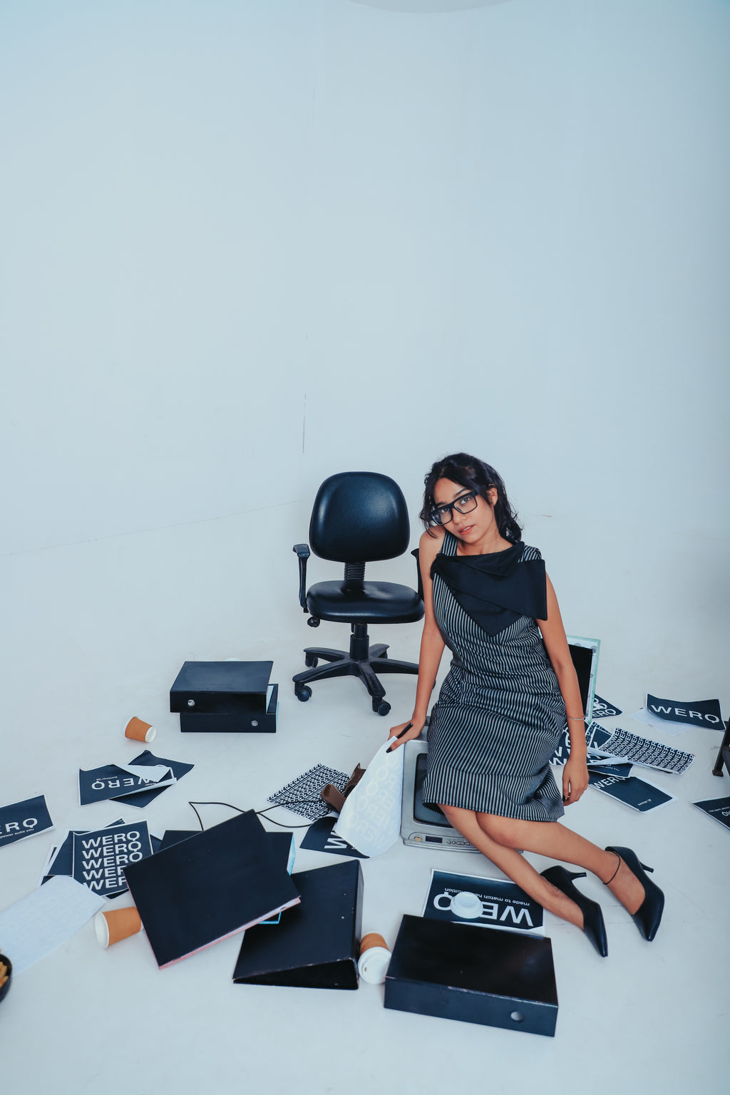 sculpted black formal dress, confident black outfit for women, pinstripe detail dress, form-fitting professional wear, statement neckline fashion, female-led outfit, smart formalwear India, black office dress, structured black powerwear, high-end formal f