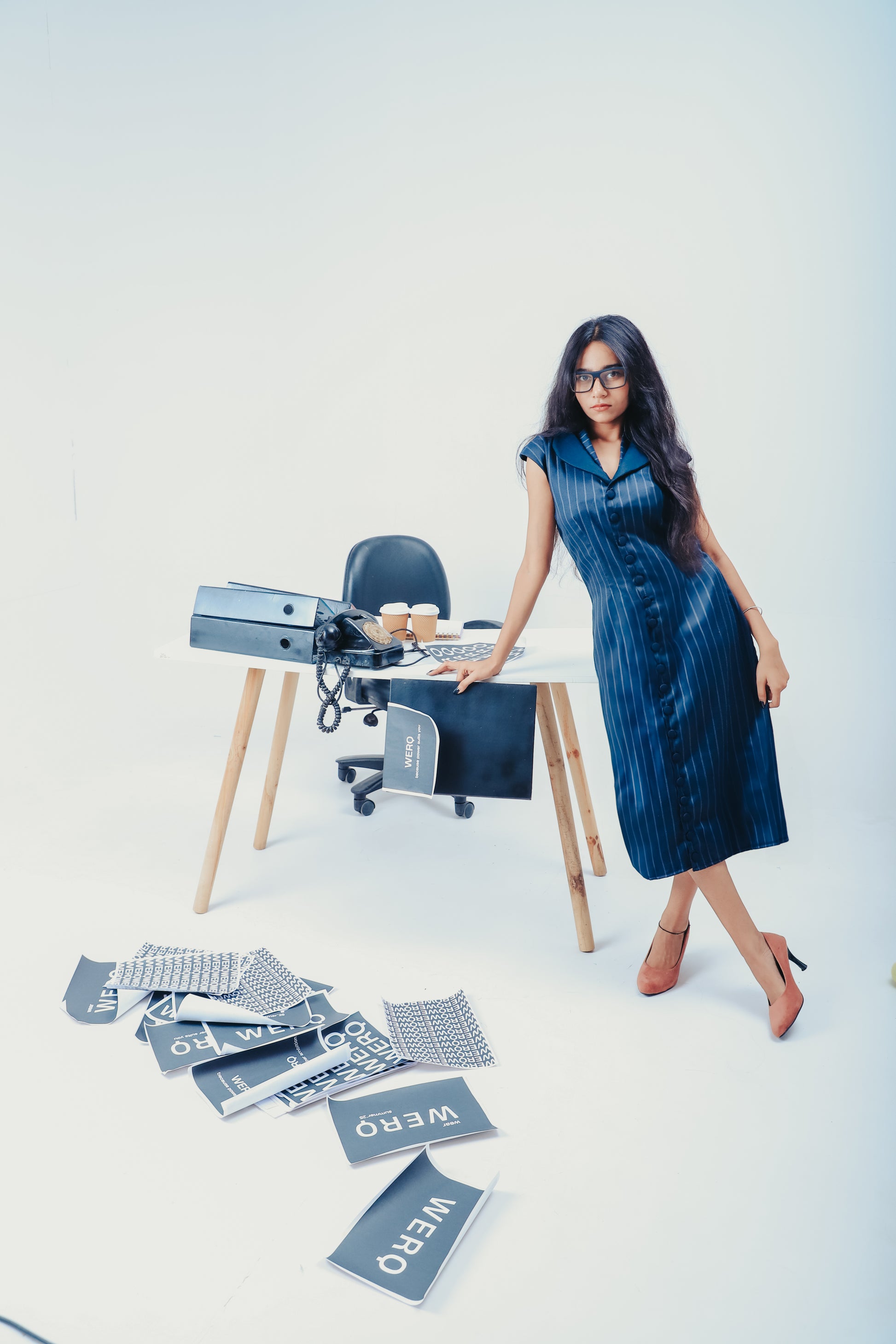 double collar dress, button down sheath dress, calf-length sheath dress, fitted formal dress, straight fit dress for women, vertical stripe office dress, soft tailoring women, workwear dress with buttons, tailored striped dress India, long shirt dress women, day-to-night dress women, modest professional dress, semi-formal sheath, smart casual dress, no-fuss workwear, clean cut work dress, sleek office wear, minimal formalwear, collar detail dress, understated work dress,  woman standing in office setting